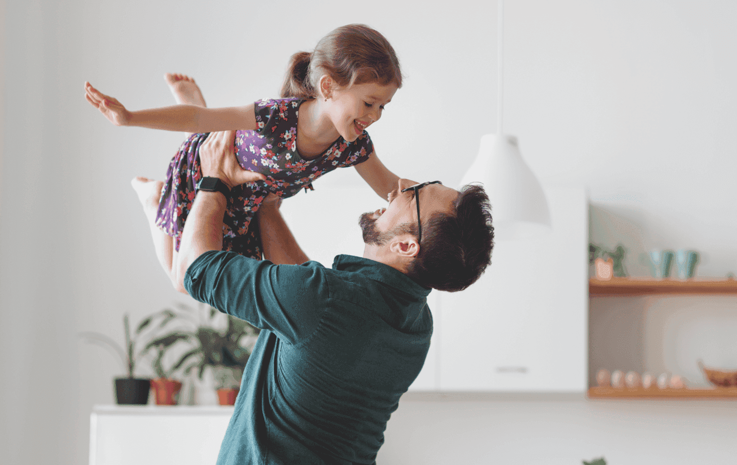 a father and daughter laughing in their home