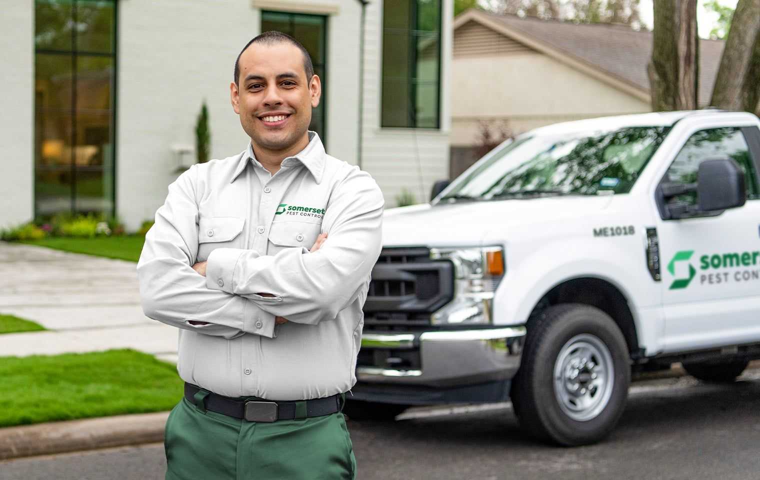 smiling tech in front of company truck