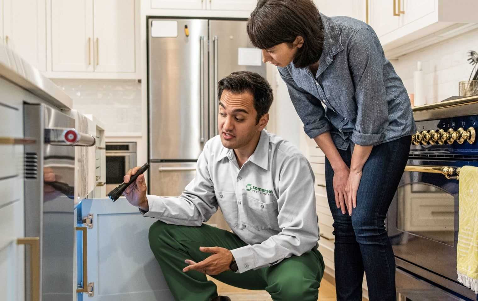 a homeowner and tech doing an inspection in a kitchen